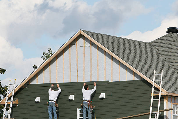 Professional Storm Damage Siding Repair technician working in Calvin, PA
